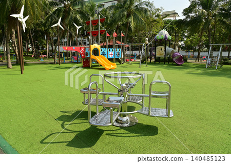 Rotating playground equipment or exercise equipment in a circular motion in a public park. Rotating playground equipment or exercise equipment in a circular motion in a public park. 140485123