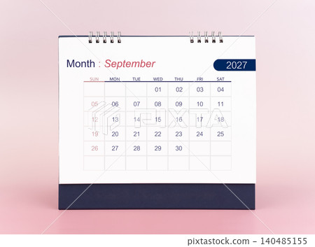 September 2027 blank desk calendar on pink background. 140485155