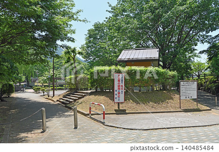 The walking path in Katsuragawa Park: A scene of public facilities surrounded by lush green trees and safety signs. The walking path in Katsuragawa Park: A scene of public facilities surrounded by lush green trees and safety signs. 140485484