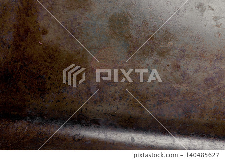 Rust streaks cover a weathered metal surface with dark patches. Textured decay Rust streaks cover a weathered metal surface with dark patches. Textured decay 140485627