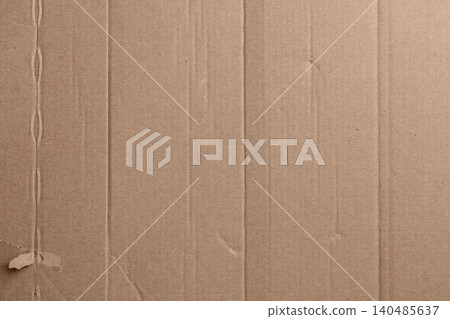 Brown cardboard texture with subtle creases and wear marks. Vertical ridges form a rhythmic pattern across the surface 140485637