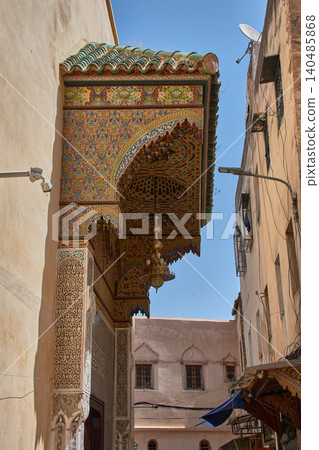 Traditional zellige mosaics decorate the carved wooden porch of the mystical Zawiya of Sidi Ahmed al-Tijani. Traditional zellige mosaics decorate the carved wooden porch of the mystical Zawiya of Sidi Ahmed al-Tijani. 140485868