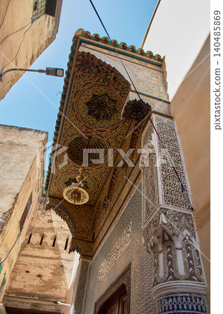 Traditional zellige mosaics decorate the carved wooden porch of the mystical Zawiya of Sidi Ahmed al-Tijani. 140485869