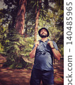 man with backpack travelling in rainforest 140485965