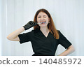 skilled aesthetician woman professional wearing black medical suit holding syringes 140485972