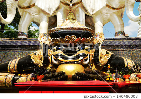 Rahu statue, the demon who causes eclipses, In Thailand, it is believed that this demon eats the moon, causing a lunar eclipse. He is eating spheres. Located at Wat Khun Jun temple in Bangkok,Thailand Rahu statue, the demon who causes eclipses, In Thailand, it is believed that this demon eats the moon, causing a lunar eclipse. He is eating spheres. Located at Wat Khun Jun temple in Bangkok,Thailand 140486008