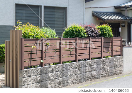 Residential privacy fence and houseplants 140486063