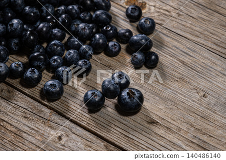 Fresh Blueberries Piled on Rustic Wooden Surface. Fresh Blueberries Piled on Rustic Wooden Surface. 140486140
