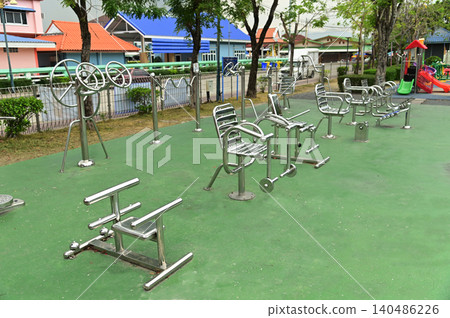 A variety of stainless steel exercise equipment is available for users to enjoy in Bang Sai Park, a local public park. 140486226