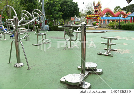 A variety of stainless steel exercise equipment is available for users to enjoy in Bang Sai Park, a local public park. A variety of stainless steel exercise equipment is available for users to enjoy in Bang Sai Park, a local public park. 140486229