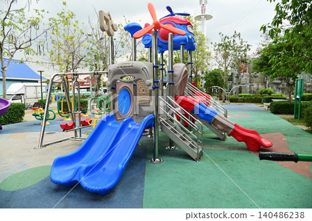 Climbing structures and slides are playground equipment for children, which are part of the public park. Climbing structures and slides are playground equipment for children, which are part of the public park. 140486238