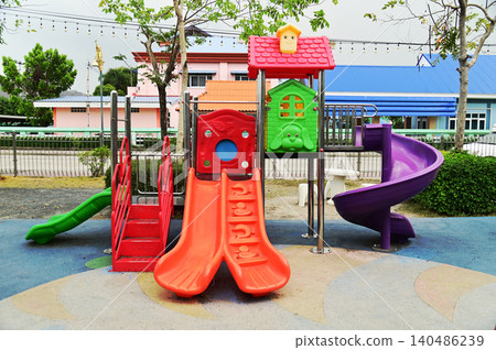 Climbing structures and slides are playground equipment for children, which are part of the public park. Climbing structures and slides are playground equipment for children, which are part of the public park. 140486239