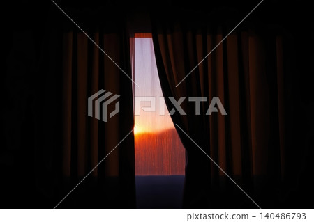First rays of sunrise illuminating a window with flowing curtains in a tranquil setting First rays of sunrise illuminating a window with flowing curtains in a tranquil setting 140486793