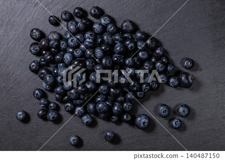 Fresh Blueberries Piled on Granite Surface. Fresh Blueberries Piled on Granite Surface. 140487150