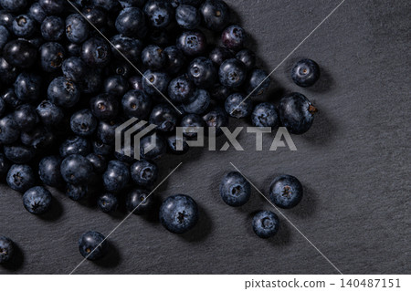 Fresh Blueberries Piled on Granite Surface. Fresh Blueberries Piled on Granite Surface. 140487151
