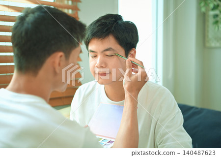 Photo set of LGBTQ applying glitter makeup with partner Photo set of LGBTQ applying glitter makeup with partner 140487623