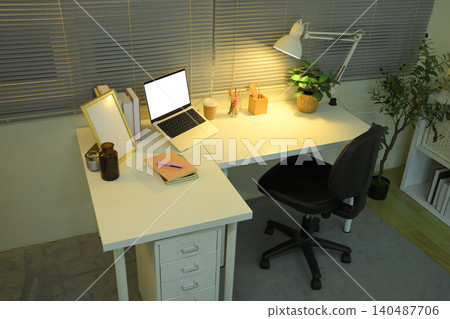 Top view home office desk with laptop mockup and warm lamp lighting Top view home office desk with laptop mockup and warm lamp lighting 140487706