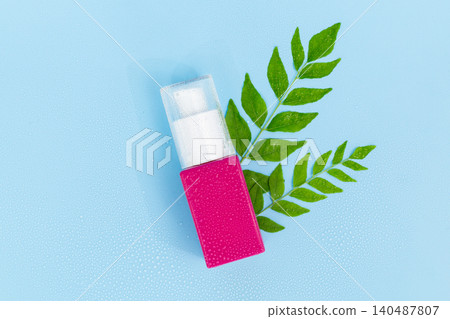 Pink pump bottle rests beside green leaves. Clean design hints at natural skincare. Bright background draws focus to product. Minimalist style suits modern beauty campaigns Pink pump bottle rests beside green leaves. Clean design hints at natural skincare. Bright background draws focus to product. Minimalist style suits modern beauty campaigns 140487807