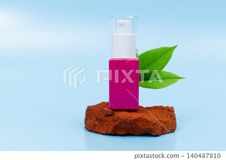 Pink bottle sits on rusted stone. Green leaf beside it adds natural touch. Clear cap and minimalist design stand out. Soft blue backdrop emphasizes calmness. Ideal for health, beauty, Pink bottle sits on rusted stone. Green leaf beside it adds natural touch. Clear cap and minimalist design stand out. Soft blue backdrop emphasizes calmness. Ideal for health, beauty, 140487810