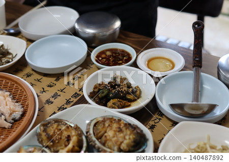 Traditional Asian Meal with Various Dishes on Table Traditional Asian Meal with Various Dishes on Table 140487892