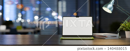 3D Computer Laptop with blank screen on table at night time 3D Computer Laptop with blank screen on table at night time 140488015