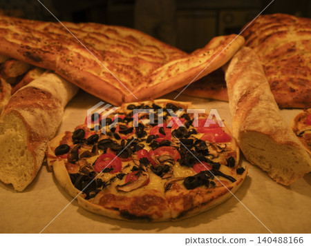 fresh pizza and breads in a bakery 140488166