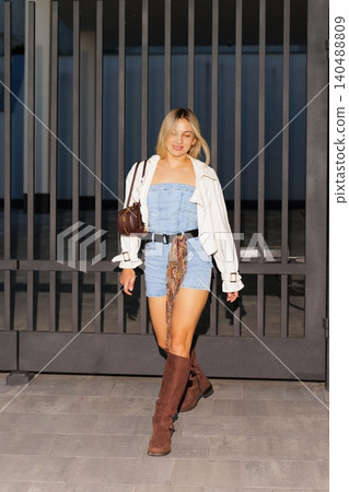 Woman posing in street style denim romper 140488809