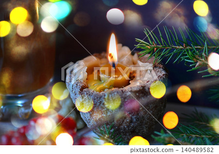 Christmas candle on the festive table. Lighted candle as religious tradition symbol in Ukraine. Christmas burning candle. Christmas candle on the festive table. Lighted candle as religious tradition symbol in Ukraine. Christmas burning candle. 140489582