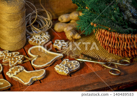 Gingerbread on Christmas table with fir branches and winter spices. Bright sprinkles enhance cheerful holiday theme. Gingerbread on Christmas table with fir branches and winter spices. Bright sprinkles enhance cheerful holiday theme. 140489583