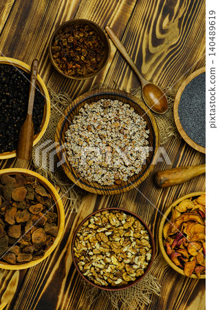 Cultural holiday food concept representing Ukrainian Christmas culinary tradition. Traditional Ukrainian Christmas kutya with ingredients and candle. Cultural holiday food concept representing Ukrainian Christmas culinary tradition. Traditional Ukrainian Christmas kutya with ingredients and candle. 140489619