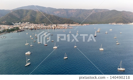 Sunset coastal city. Boats coastal town. Coastal mountain landscape, sea resort yachts, golden hour Sunset coastal city. Boats coastal town. Coastal mountain landscape, sea resort yachts, golden hour 140490218
