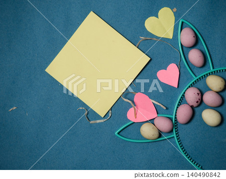 Easter display with bunny rabbit ears and eggs blue background Easter display with bunny rabbit ears and eggs blue background 140490842