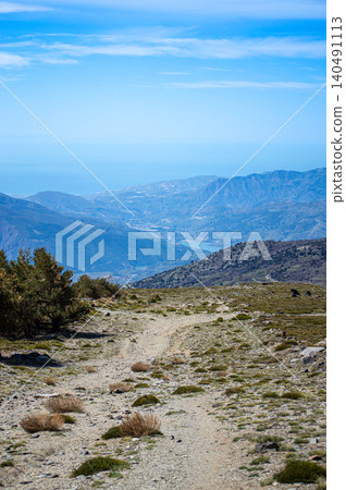 Hiking trail to Mulhacen peak in the spring in Sierra Nevada National Park, Spain Hiking trail to Mulhacen peak in the spring in Sierra Nevada National Park, Spain 140491113