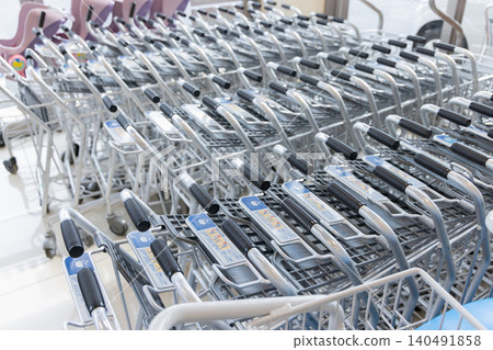 Shopping carts lined up at the supermarket entrance Shopping carts lined up at the supermarket entrance 140491858