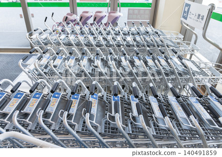 Shopping carts lined up at the supermarket entrance Shopping carts lined up at the supermarket entrance 140491859