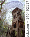 Wooden tower and mesh tunnels in forest adventure park 140492117