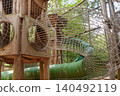 Wooden tower and mesh tunnels in forest adventure park 140492119