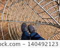 Point of view inside metal mesh tunnel at adventure park 140492123