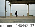 A woman gazing at the sea at Shimonada Station 140492137