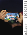 Taking photos of the illuminated cherry blossoms at Chidorigafuchi with a smartphone. 140492321