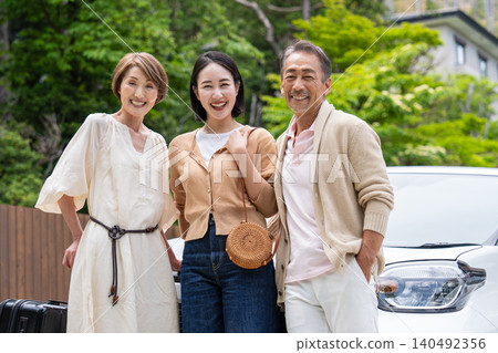 A senior couple and their daughter's family traveling by car A senior couple and their daughter's family traveling by car 140492356