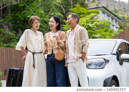 A senior couple and their daughter's family traveling by car A senior couple and their daughter's family traveling by car 140492357