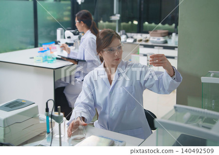 Scientist Conducting Chemical Analysis in Laboratory Setting 140492509