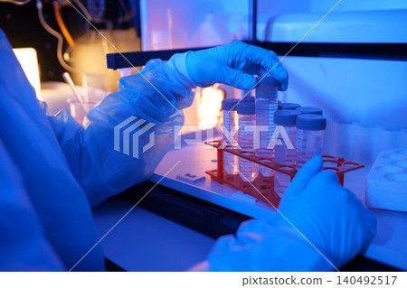 Laboratory Technician Organizing Test Tubes for Scientific Experiments Laboratory Technician Organizing Test Tubes for Scientific Experiments 140492517