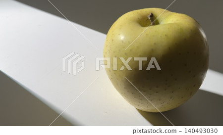Yellow Japanese pears on a white table bathed in natural light. Yellow Japanese pears on a white table bathed in natural light. 140493030