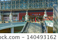 Kanazawa, Japan - Oct 6 2024, panoramic view of the entrance to Kanazawa Station with Motenashi Dome above, with a staircase in the foreground and people walking around, at daytime, Kanazawa, Japan  140493162