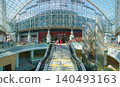 Kanazawa, Japan - Oct 6 2024, panoramic view of the entrance to Kanazawa Station with Motenashi Dome above, with a staircase in the foreground and people walking around, at daytime, Kanazawa, Japan  140493163
