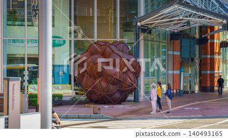 Kanazawa, Japan - Oct 6 2024, A panoramic view of the modern metal sculpture Corpus Minor 1, near Kanazawa Station, with people walking past in the foreground, at daytime, Kanazawa, Japan Kanazawa, Japan - Oct 6 2024, A panoramic view of the modern metal sculpture Corpus Minor 1, near Kanazawa Station, with people walking past in the foreground, at daytime, Kanazawa, Japan 140493165