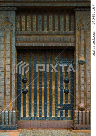 Kanazawa, Japan - Oct 6 2024, A vertical view of a wooden door with metal stripes at the entrance gate of Kanazawa Castle, Kanazawa, Japan Kanazawa, Japan - Oct 6 2024, A vertical view of a wooden door with metal stripes at the entrance gate of Kanazawa Castle, Kanazawa, Japan 140493167