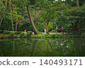 Kanazawa, Japan - Oct 6 2024, panoramic view of the mirror-like pond in Kenroku-en Park, with people strolling along the coastline in the background, at daytime, Kanazawa, Japan  140493171